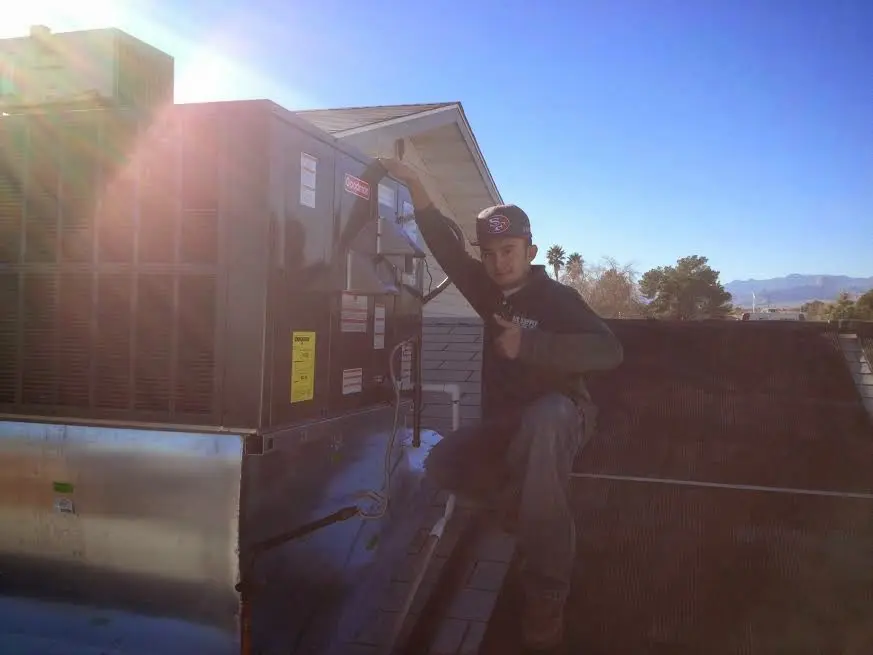 HVAC technician performing HVAC Inspection on a rooftop unit in North Versailles